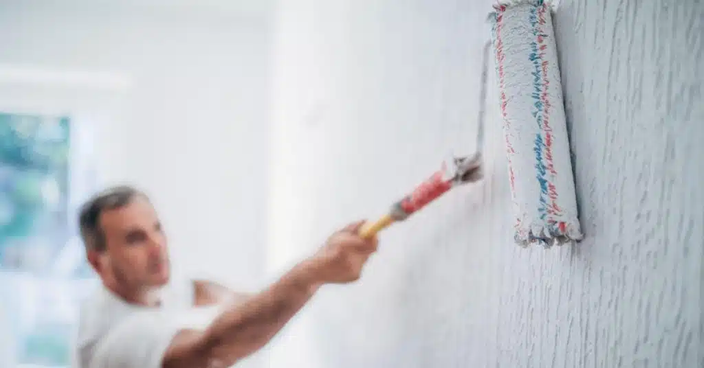 Painter at work with a paint roller